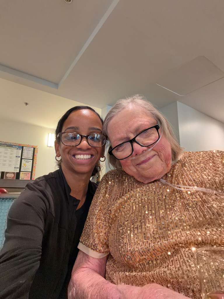 Meishael sharing a genuine moment of care and joy with a client